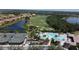 Beautiful aerial view of the community's pool, tennis courts, lake, and golf course at 6740 Willowshire Way, Bradenton, FL 34212