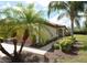 Charming home featuring lush landscaping, a terracotta roof, and a welcoming entryway at 6740 Willowshire Way, Bradenton, FL 34212