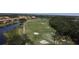 Scenic golf course view with ponds, sand traps, and lush landscaping in a residential area at 6740 Willowshire Way, Bradenton, FL 34212