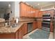Well-equipped kitchen features wood cabinets, granite countertops, and stainless steel appliances at 6740 Willowshire Way, Bradenton, FL 34212