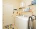Laundry room with washer, dryer, shelving, and storage space at 6740 Willowshire Way, Bradenton, FL 34212