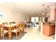Bright, open living space with dining area, tile floors, and sliding glass doors to the patio at 6740 Willowshire Way, Bradenton, FL 34212