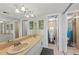 Bright bathroom boasts double sinks, neutral finishes, and decoratively-framed tropical themed pictures on the wall at 707 S Gulfstream Ave # 501, Sarasota, FL 34236