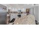 Close-up of a modern kitchen showcasing granite counters and updated appliances at 707 S Gulfstream Ave # 501, Sarasota, FL 34236