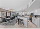 Bright kitchen with stainless appliances open to a dining area with modern glass table at 707 S Gulfstream Ave # 501, Sarasota, FL 34236