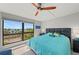 Bright primary bedroom with a large window overlooking a scenic view and modern ceiling fan at 707 S Gulfstream Ave # 501, Sarasota, FL 34236