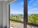 Serene water view featuring lush green spaces and a scenic palm tree-lined street from a bright window at 707 S Gulfstream Ave # 501, Sarasota, FL 34236