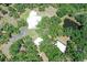 Aerial view of white modern home and estate including a pond at 7200 Chameleon Way, Sarasota, FL 34241