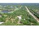 Aerial view of modern estate with surrounding golf course and lush landscape at 7200 Chameleon Way, Sarasota, FL 34241
