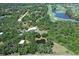 Aerial view of an estate home near a golf course and pond at 7200 Chameleon Way, Sarasota, FL 34241