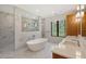Modern bathroom with a soaking tub, marble shower, and double vanity at 7200 Chameleon Way, Sarasota, FL 34241