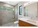 Modern bathroom with a glass-enclosed shower, sleek vanity, and nature views at 7200 Chameleon Way, Sarasota, FL 34241
