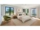 Serene bedroom with natural light, a plush bed, and calming views of the outdoors from the large windows at 7200 Chameleon Way, Sarasota, FL 34241