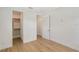Bright, modern bedroom with hardwood floors and access to a walk-in closet at 7200 Chameleon Way, Sarasota, FL 34241