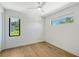 Bright bedroom with hardwood floors and modern windows overlooking the landscaped exterior at 7200 Chameleon Way, Sarasota, FL 34241
