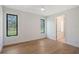 Spacious bedroom with hardwood floors, white walls, and large windows providing natural light at 7200 Chameleon Way, Sarasota, FL 34241