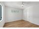 Bright bedroom with hardwood floors, a modern ceiling fan, and a window with natural light at 7200 Chameleon Way, Sarasota, FL 34241
