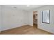 Hardwood floors, white walls and trim and doors to a closet and hallway at 7200 Chameleon Way, Sarasota, FL 34241