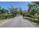 Long driveway leading to the house, surrounded by mature trees and lush greenery at 7200 Chameleon Way, Sarasota, FL 34241