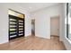 Bright foyer with wood floors, tall ceilings and a modern front door with glass inserts at 7200 Chameleon Way, Sarasota, FL 34241