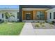 Modern home featuring clean lines, wood accents, lush landscaping and a contemporary front door at 7200 Chameleon Way, Sarasota, FL 34241