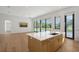 Open-concept kitchen with a large island, modern finishes, and seamless access to the outdoor patio at 7200 Chameleon Way, Sarasota, FL 34241