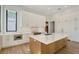 Stylish kitchen features a large island, custom cabinets, stainless steel appliances, and modern lighting at 7200 Chameleon Way, Sarasota, FL 34241