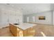 Modern kitchen island with white countertop and custom cabinets in an open-concept living space at 7200 Chameleon Way, Sarasota, FL 34241