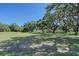 Vacant grass-covered lot with mature trees and Spanish moss at 7200 Chameleon Way, Sarasota, FL 34241