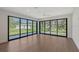 Sun-drenched living room with hardwood floors and panoramic views of the backyard at 7200 Chameleon Way, Sarasota, FL 34241