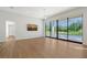 Bright living room featuring hardwood floors, large windows, and a sliding glass door at 7200 Chameleon Way, Sarasota, FL 34241