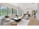 Bright open-concept living room featuring large windows, a comfortable sofa, and modern decor at 7200 Chameleon Way, Sarasota, FL 34241
