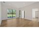 Spacious living room with hardwood floors and large window with a view of the outdoors at 7200 Chameleon Way, Sarasota, FL 34241