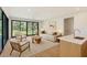 Stylish living room with expansive windows offering scenic views and comfortable seating around a central coffee table at 7200 Chameleon Way, Sarasota, FL 34241