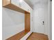 Mud room with built-in wood bench and storage at 7200 Chameleon Way, Sarasota, FL 34241