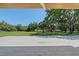 Spacious paved patio offering serene views of mature trees and landscaped grounds at 7200 Chameleon Way, Sarasota, FL 34241