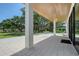 Covered outdoor patio featuring tile flooring and views of the lush surroundings at 7200 Chameleon Way, Sarasota, FL 34241