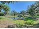 Picturesque pond surrounded by lush greenery and mature trees at 7200 Chameleon Way, Sarasota, FL 34241