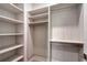 Spacious walk-in closet featuring built-in shelving and ample hanging space at 7200 Chameleon Way, Sarasota, FL 34241