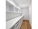 Bright walk-in closet with long marble countertop and hardwood floors at 7200 Chameleon Way, Sarasota, FL 34241