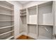 Open walk-in closet with custom shelving and rods for versatile storage solutions at 7200 Chameleon Way, Sarasota, FL 34241