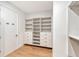 Walk-in closet featuring built-in shelves and drawers for optimal storage and organization at 7200 Chameleon Way, Sarasota, FL 34241