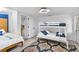 Cozy bedroom featuring a bunk bed, soft lighting, and patterned rug at 7795 Wright Ave, Sarasota, FL 34231