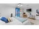 Bright bedroom featuring a queen bed with stylish décor, comfortable seating, and a mirrored accent wall at 7795 Wright Ave, Sarasota, FL 34231