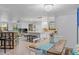 Open concept dining area leading to kitchen, providing ample seating with rustic wood table and chairs at 7795 Wright Ave, Sarasota, FL 34231