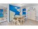 Charming dining area featuring an accent wall with a custom design and ample seating for Gathering and guests at 7795 Wright Ave, Sarasota, FL 34231