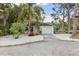 Charming home with a well-maintained exterior, a garage, and attractive landscaping with white gravel at 7795 Wright Ave, Sarasota, FL 34231