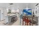Modern white kitchen featuring a large island with bar seating and stainless steel appliances at 7795 Wright Ave, Sarasota, FL 34231
