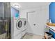 Bright laundry room with modern washer, dryer, and ample storage space at 7795 Wright Ave, Sarasota, FL 34231