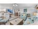 Bright and airy living room with an open floorplan, light hardwood floors, and comfortable modern furniture at 7795 Wright Ave, Sarasota, FL 34231